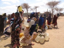 Women wait with water