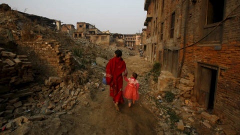 Women walk through a street in Nepal which has been affected by the earthquake