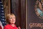 Hillary Clinton speaks from a podium at Georgetown