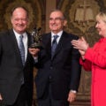Hillary Clinton presents an award to Mr. De la Calle