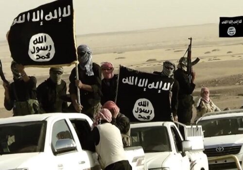 ISIS members drive in white cars and carry large ISIS flags