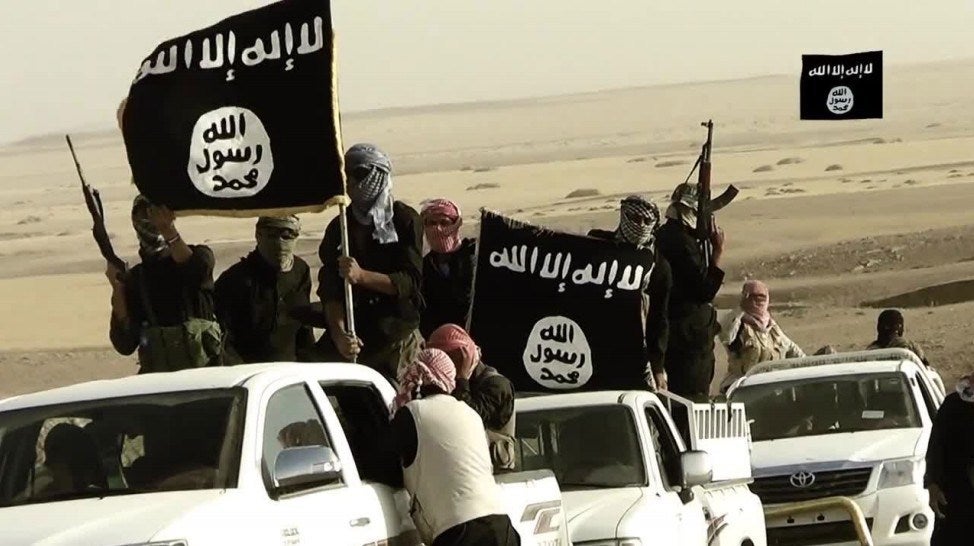 ISIS members drive in white cars and carry large ISIS flags