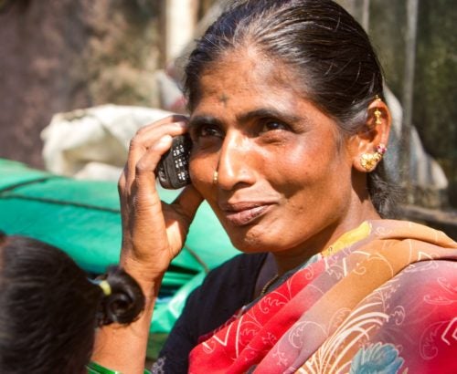 Woman using mobile phone in India