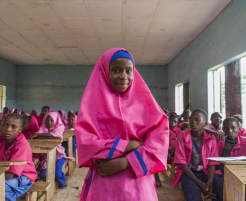 Nailatu Al-Quasm, 12, stands in her classroom at Gyezmo primary school in the town of Toro, Bauchi State. Other students are nearby. Their school is among the beneficiaries of the Girls Education Project (GEP). Led by the Government with support from the United Kingdoms Department of International Development (DFID) and UNICEF, the GEP aims to get 1 million more girls into school by 2020, while at the same improving the quality of education. The project also calls for the deployment of more than 10,000 female teachers to rural areas, where the predominance of male teachers deters many parents from sending their girls to school. Nailatu enrolled in school during the GEPs kick off in Bauchi. Her father, Kasimu Limon Toro, who now runs a traditional Koranic school in a hut near the familys home, did not learn to write until he attended adult literacy classes, but he insists that all his 15 children including the 11 girls must get a good education. I will support her in this with all my heart, until the day I die, he said of Nailatus dreams of becoming a doctor. I want to help people. I want to help my mother, my father, my brothers, my sisters, said Nailatu.