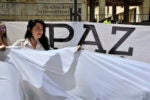 A woman holds a white flag during a demonstration to demand the immediate endorsement of the new peace agreement between the Colombian government and the FARC guerrilla outside the Colombia's Constitutional Court in Bogota, on December 12, 2016. Colombian Constitutional Court has to debate the approval of a fast track mechanism that would speed up voting on bills linked to the peace process, including amnesty for FARC guerrillas. The Colombia's Congress approved the government's controversial revised peace deal to end a half-century conflict with leftist FARC rebels after voters on October 2 surprisingly snubbed an earlier version of the accord in a referendum. / AFP / Guillermo LEGARIA (Photo credit should read GUILLERMO LEGARIA/AFP/Getty Images)