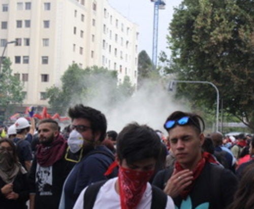 Protesters in Chile with face masks to guard against tear glass