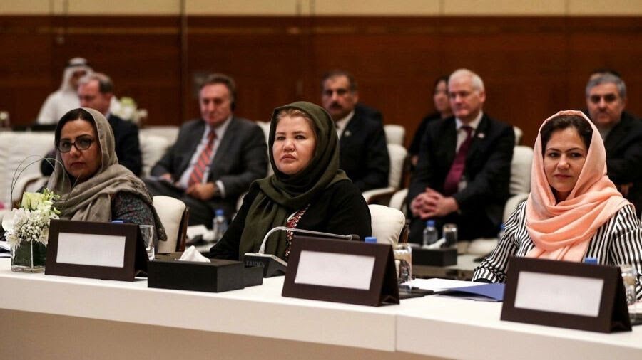 Photo of three women negotiators sitting on a panel