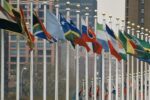 An image of a group of flags from countries around the world is included for decorative purposes