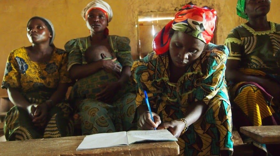 Photo of three women gathered around a table that illustrates the concept of making the law work for women.