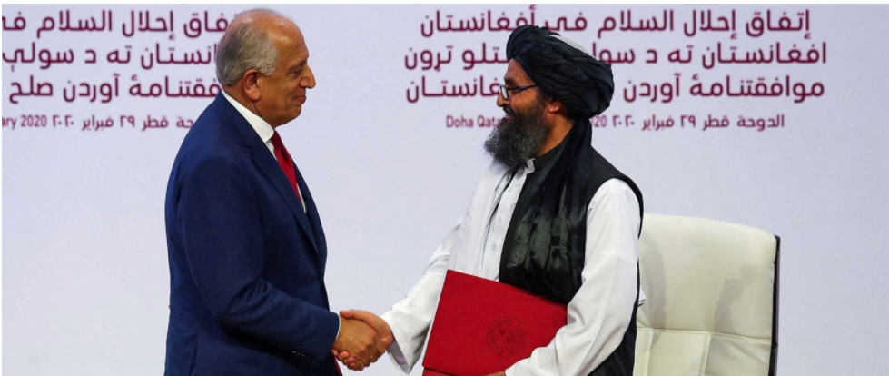 Photo taken at the US-Taliban peace talks in 2020 shows two men shaking hands.