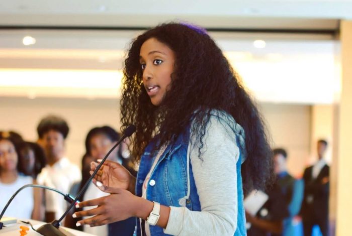 A photo of Bserat Ghebremicael, the person interviewed in this blog post, speaking to Black college students across the United States, discussing the role of Black consumers in technology