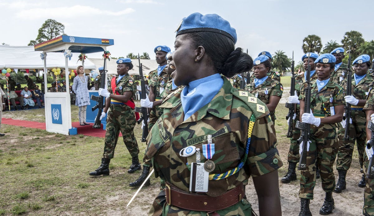 A decorative image taken from the report mentioned on this page shows a woman soldier in a peacekeeping uniform smiling at other soldiers in a group.