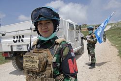 A decorative image taken from the report mentioned on this page shows a woman soldier in a helmet and peacekeeping uniform standing in front of a UNIFIL truck.