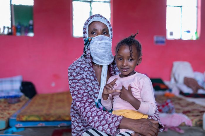 An image of a woman and young girl in an Internally Displaced Persons camp in Ethiopia taken by a UNICEF photographer shows the negative impacts of the crisis in Tigray on individuals who have been forced from their homes.