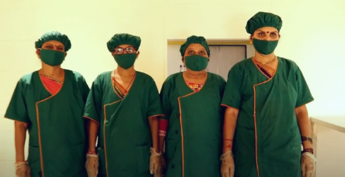A decorative image shows members of the Self-Employed Women's Association, the organization featured in the article on this page, wearing personal protective equipment and face masks.