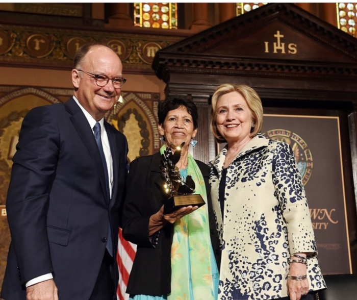 A photo of Virginia Velasquez, the person described in this post, receiving an award from Hillary Clinton at Georgetown in 2019.