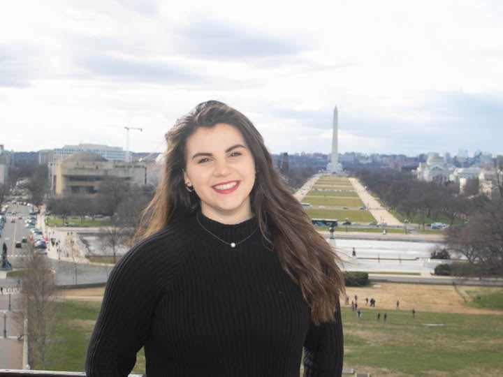 Grace Shevchenko poses with the Washington Monument in the background.