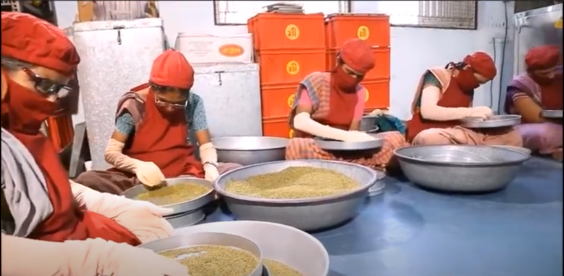 A decorative image shows women wearing face masks sorting grain in large bowls. The women are self-employed farmers affiliated with SEWA, the organization featured in this article.